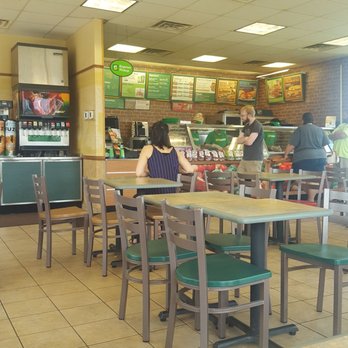 Subway - a woman sitting at a table in a restaurant - Sandwiches Near Me - Rolla, Missouri