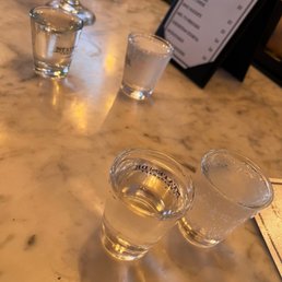three shot glasses on a marble table three shot glasses on a marble table