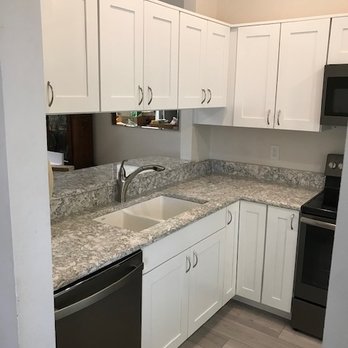 A Kitchens by Wheaton - a kitchen with white cabinets and black appliances - Cabinetry Near Me - Saint Petersburg, Florida A Kitchens by Wheaton - a kitchen with white cabinets and black appliances - Cabinetry Near Me - Saint Petersburg, Florida