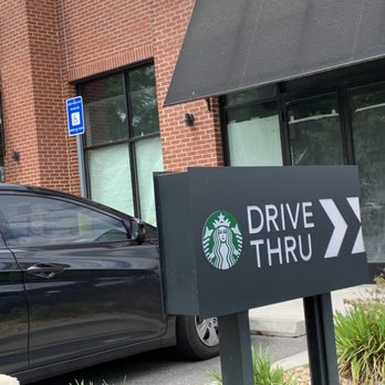 Starbucks - a car parked in front of a starbucks drive thru sign - Coffee & Tea Near Me - Savannah, Georgia