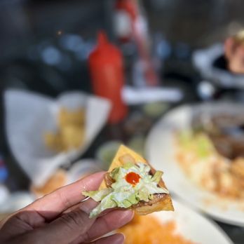 Taqueria Mi Jalisco - a hand holding a piece of pizza - Mexican Near Me - Gresham, Oregon