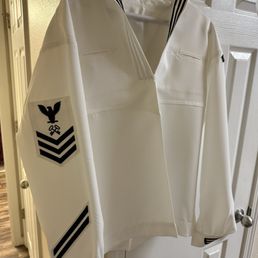 Dress whites with wrong placement of rank, service stripes and rocker.
