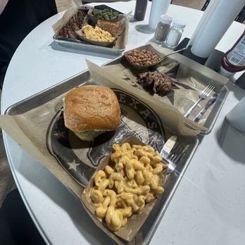 Rabel’s Roadhaus BBQ - Brisket sandwhich with jalapeno bun with Mac and cheese 1/4lbs of pulled pork and beans also with a two meat plate - Barbeque Near Me - La Vernia, Texas