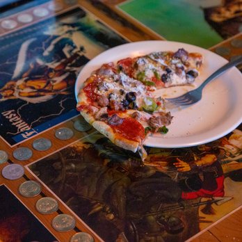 Conans Pizza South - a slice of pizza on a plate - Pizza Near Me - Austin, Texas Conans Pizza South - a slice of pizza on a plate - Pizza Near Me - Austin, Texas