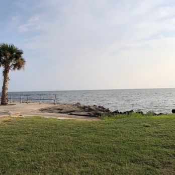 Sea Level - two palm trees on the shore of a body of water - Tacos Near Me - Pass Christian, Mississippi