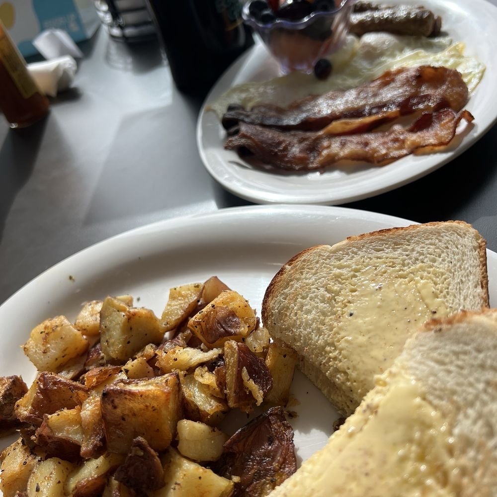 Eggs Up Grill - Grand classic plate- breakfast potatoes, toast, eggs, bacon, fruit cup - Breakfast & Brunch Near Me - Austin, Texas Eggs Up Grill - Grand classic plate- breakfast potatoes, toast, eggs, bacon, fruit cup - Breakfast & Brunch Near Me - Austin, Texas