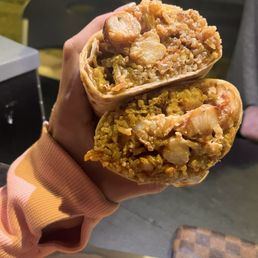 a person holding a burrito