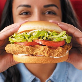 Dairy Queen - a woman holding a sandwich in front of her face - Fast Food Near Me - San Antonio, Texas Dairy Queen - a woman holding a sandwich in front of her face - Fast Food Near Me - San Antonio, Texas
