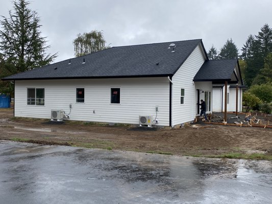Home Addition - New home addition, nearly finished. Concrete crew setting up to pour patios and walkways.