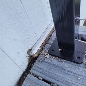 Mainline Carpentry & Construction - Rotted wood block between deck and house that was not replaced. - General Contractors Near Me