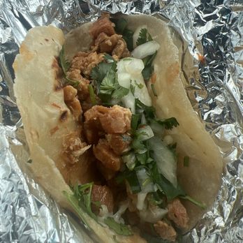 Titas Taco House - Chicharron and pork taco with beans, cilantro and onions. Delicious!!! - Tacos Near Me - Humble, Texas
