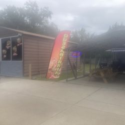 Rookies - Building with bathrooms and indoor seating next to foodtruck where you order