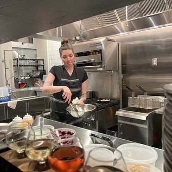 Pomona Cider - a woman preparing food in a commercial kitchen - Cideries Near Me - Milwaukee, Wisconsin Pomona Cider - a woman preparing food in a commercial kitchen - Cideries Near Me - Milwaukee, Wisconsin