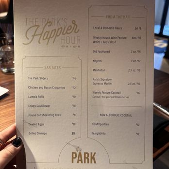 The Park - a person holding up a menu - Steakhouses Near Me - Mississauga, Ontario The Park - a person holding up a menu - Steakhouses Near Me - Mississauga, Ontario