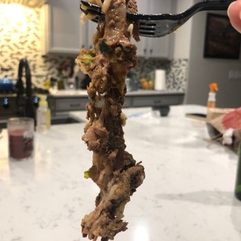 Chipotle Mexican Grill - a hand holding a fork full of food - Mexican Near Me - Wadsworth, Ohio