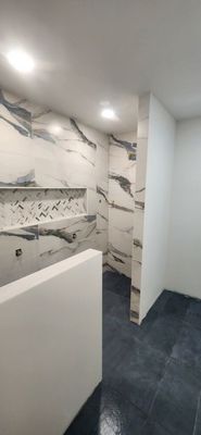 New Basement Bathroom - We roughed in new plumbing and electric in order to build a new bathroom. Bathroom has a curbless entry with shower heads on the left and right as you walk in. Wall tile is 24x48. Floor tile has texture in order to have grip as you walk when wet. New Basement Bathroom - We roughed in new plumbing and electric in order to build a new bathroom. Bathroom has a curbless entry with shower heads on the left and right as you walk in. Wall tile is 24x48. Floor tile has texture in order to have grip as you walk when wet.