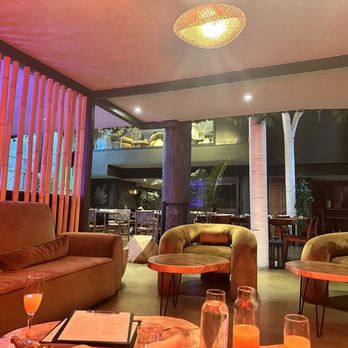 Bohemia - a living room with couches, tables, and chairs - Cocktail Bars Near Me - Brooklyn, New York