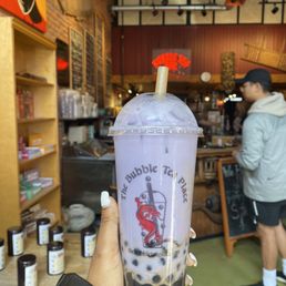 a hand holding a cup of bubble tea