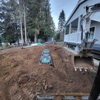 B & C Building Solutions - Digging deep! We're carefully installing the septic tank and prepping the area for pipe placement in Mason County. - General Contractors Near Me B & C Building Solutions - Digging deep! We're carefully installing the septic tank and prepping the area for pipe placement in Mason County. - General Contractors Near Me