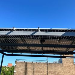 Smarter Energy Services - Up close view of the solar canopy awning we installed on the roof balcony of a new residential building in  Brooklyn, NY.