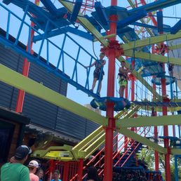 a group of children climbing on a playground structure