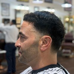 The Barber Shop - Men's curly haircut featuring detailed shear work on top and a clean low taper fade. The Barber Shop , SB.