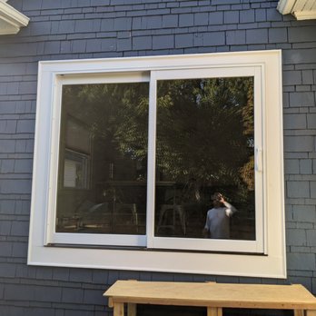 Azimuth Works - a man taking a picture of himself through a window - General Contractors Near Me - Seattle, Washington