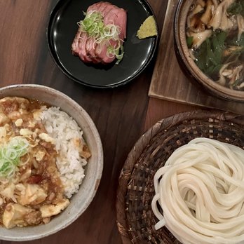 Rintaro - Mabodofu don (bottom left plate). Kamojiru udon (the other 3 plates). - Izakaya Near Me - San Francisco, California