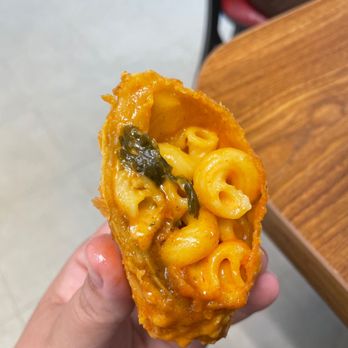 Mr Diddy's - a hand holding a piece of macaroni and cheese - Southern Near Me - Marietta, Georgia Mr Diddy's - a hand holding a piece of macaroni and cheese - Southern Near Me - Marietta, Georgia