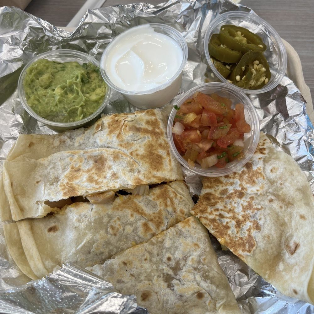 Moe's Southwest Grill - Chicken Quesadilla with: Pico de gallo, guacamole, jalapenos & sour cream... cheese queso for the tortilla chips under the foil - Mexican Near Me - Schofield Barracks, Hawaii Moe's Southwest Grill - Chicken Quesadilla with: Pico de gallo, guacamole, jalapenos & sour cream... cheese queso for the tortilla chips under the foil - Mexican Near Me - Schofield Barracks, Hawaii