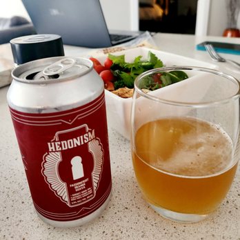 Kichesippi Beer Co. - a glass of beer next to a can of hedonism - Breweries Near Me - Ottawa, Ontario Kichesippi Beer Co. - a glass of beer next to a can of hedonism - Breweries Near Me - Ottawa, Ontario