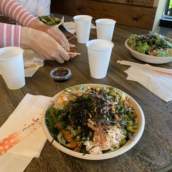 Poke Tiki - a woman eating a salad at a restaurant - Hawaiian Near Me - Irvine, California Poke Tiki - a woman eating a salad at a restaurant - Hawaiian Near Me - Irvine, California