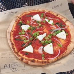 Vegan pizza with red sauce, vegan cheese, basil, green pepper and onion Vegan pizza with red sauce, vegan cheese, basil, green pepper and onion