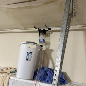 McLeran Roofing & Gutters - Garage ceiling leak: Water dripping down like a river and my Mcguyver attempt to route water to the sink below - Roofing Near Me