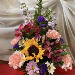 Justice Flower Shop - mixed color and style flowers arranged in a pink container