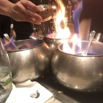 The Melting Pot - Adding cinnamon to the bananas foster to make it sparkle. - Fondue Near Me - Maple Shade, New Jersey