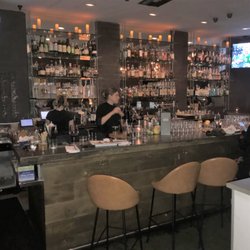 Full bar with seating at the bar or tables in the bar area.