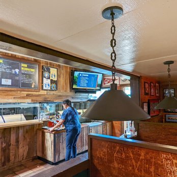Dutch Goose - a man standing at a counter in a restaurant - Pubs Near Me - Menlo Park, California Dutch Goose - a man standing at a counter in a restaurant - Pubs Near Me - Menlo Park, California