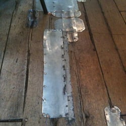 Hobnob Corner - Old floor being mended by metal strips. Lots of character!