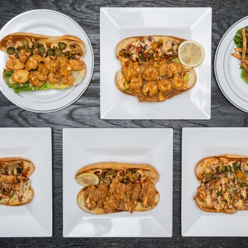 PoBoyz - four plates of food on a table - Seafood Near Me - Chicago, Illinois