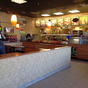 Subway - a man sitting at a table in a restaurant - Fast Food Near Me - Cobleskill, New York