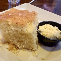 On the house corn bread....so moist and fluffy! Served warm with sweet tasty butter On the house corn bread....so moist and fluffy! Served warm with sweet tasty butter