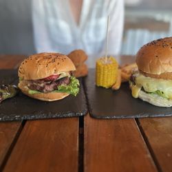Mamalonas Burgers - Miserable Texana burger and Mamalosa Onion Cheeseburger with sides of stuffed jalapeño, corn, onion ring, and fries