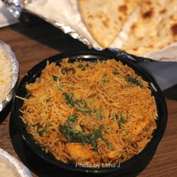 Tandav Indian Cuisine Halal Food - Fish Biryani ($16.95) Salmon marinated in yogurt, tomatoes, herbs and spices, cooked with spiced flavored Basmati rice and saffron.