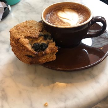 Think Coffee - Blueberry buttermilk scone (half eaten) and a cortado - Coffee & Tea Near Me - New York, New York Think Coffee - Blueberry buttermilk scone (half eaten) and a cortado - Coffee & Tea Near Me - New York, New York