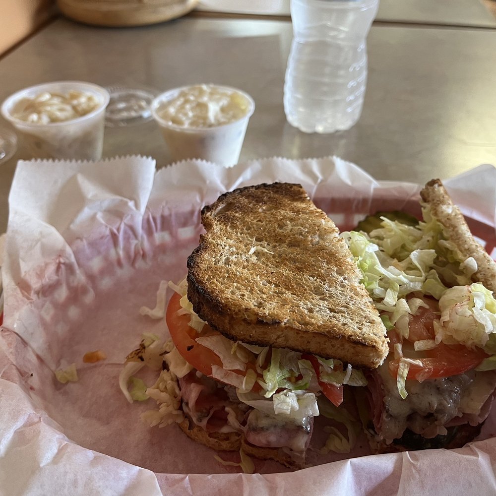 Manny's Combo on deli bread with sides of potato salad and macaroni salad.