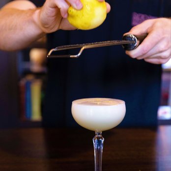 The Norfolk Pub - a person squeezing a lemon into a cocktail glass - American Near Me - Norfolk, Connecticut The Norfolk Pub - a person squeezing a lemon into a cocktail glass - American Near Me - Norfolk, Connecticut