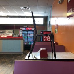 Chair on top of every other table with sign not using due to Covid. Chair on top of every other table with sign not using due to Covid.