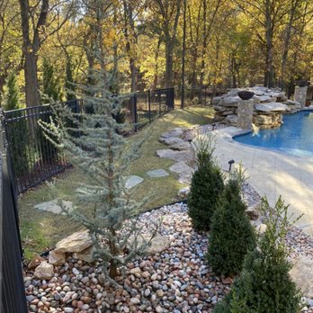 Rockwell Irrigation & Landscaping - Blue Atlas Cedar Tree Installation in Rock Bed - Irrigation Near Me - Broken Arrow, Oklahoma Rockwell Irrigation & Landscaping - Blue Atlas Cedar Tree Installation in Rock Bed - Irrigation Near Me - Broken Arrow, Oklahoma