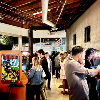 EightyTwo - a group of people playing a video game - Bars Near Me - Los Angeles, California